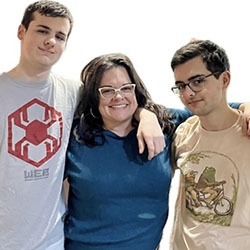 A mother and two teen sons pose for a picture