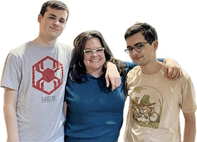A mother and two teen sons pose for a picture