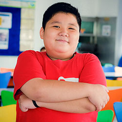Male patient with arms folded, smiling