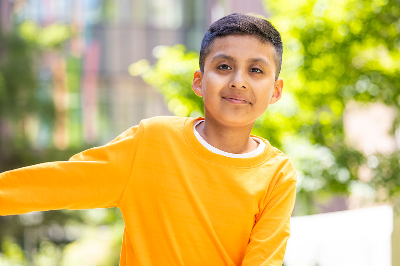 A boy stands outside