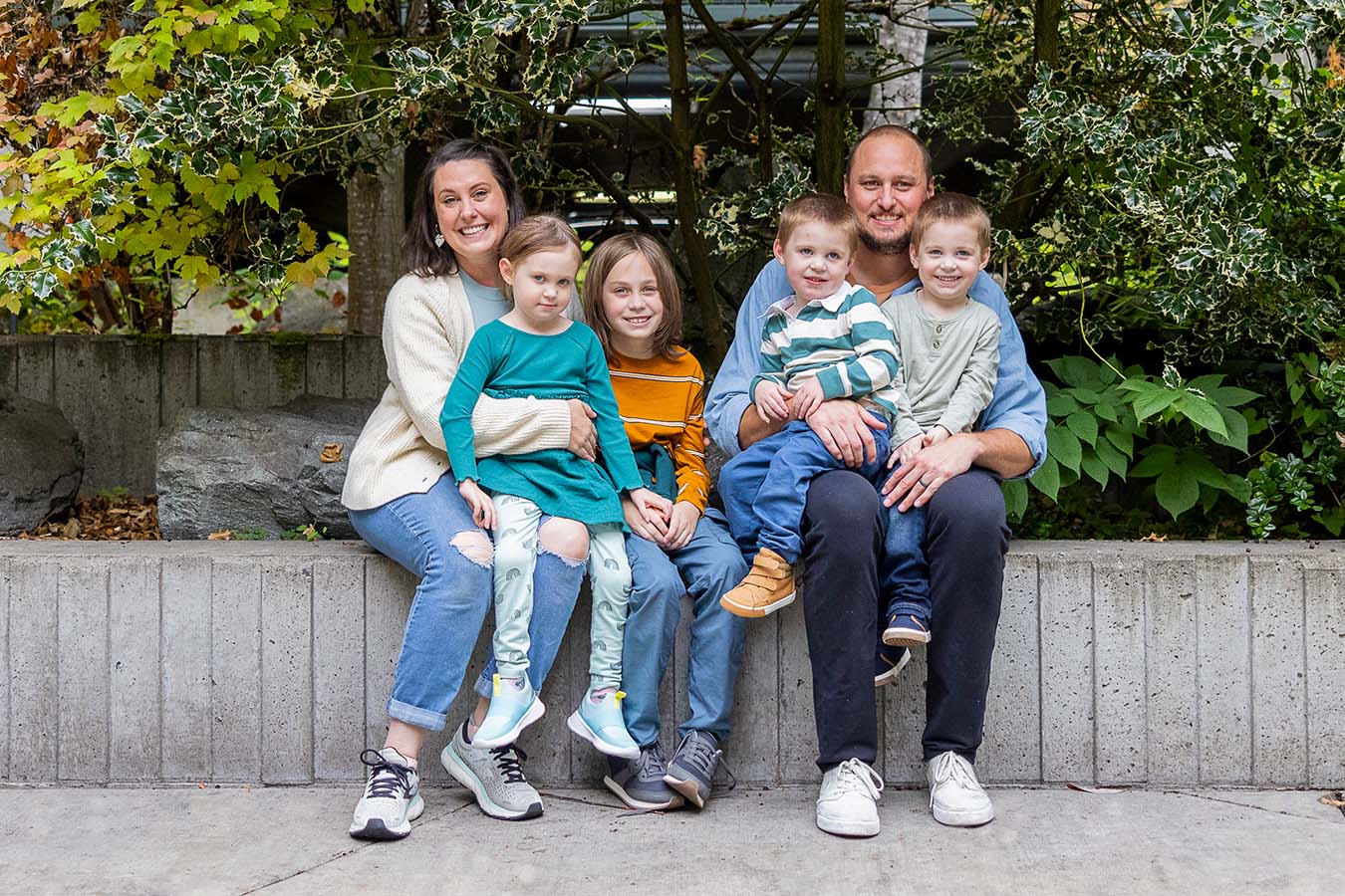 A family poses for the camera outside