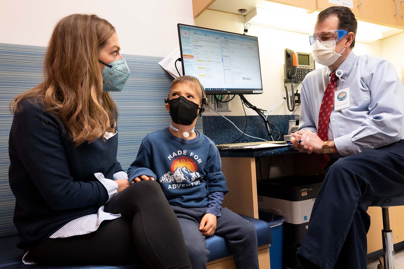 A mother and son speak with a Seattle Children’s doctor