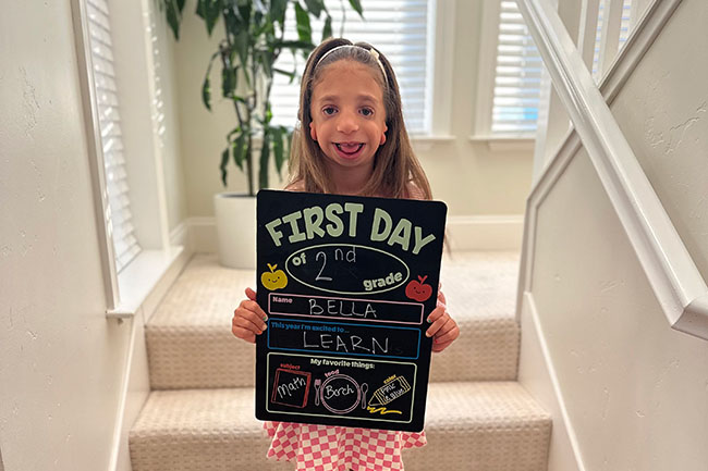 A girl holding a 1st day sign