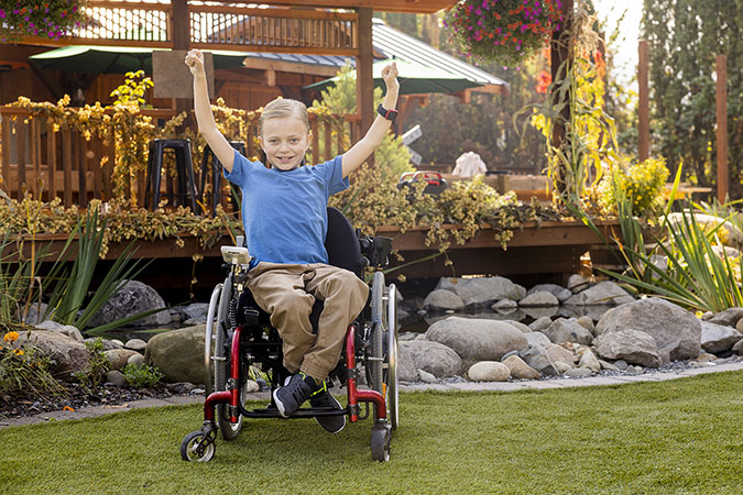 Child posing in his wheelchair
