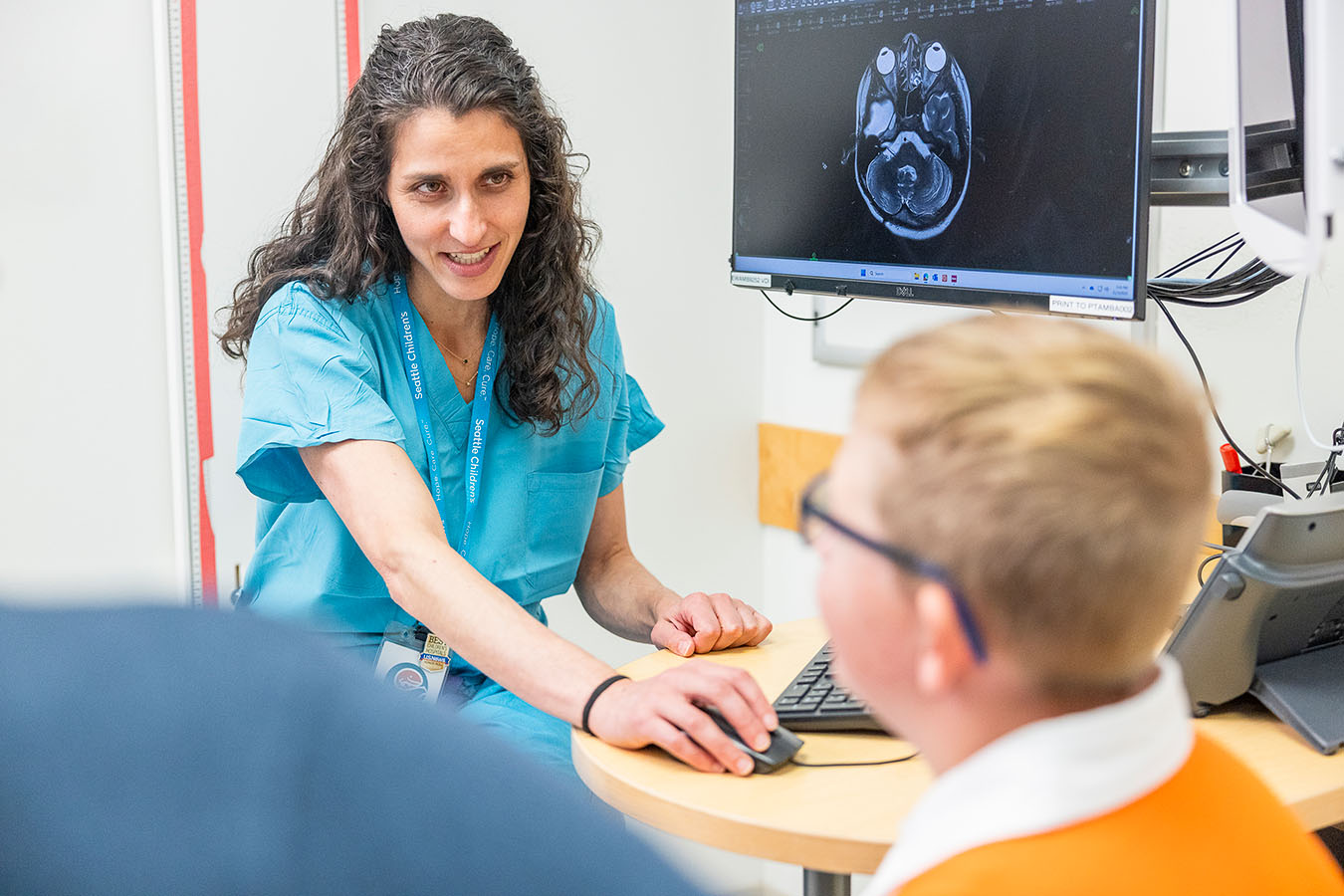 A doctor shows brain scans to a patient