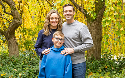 A family poses for a picture outside