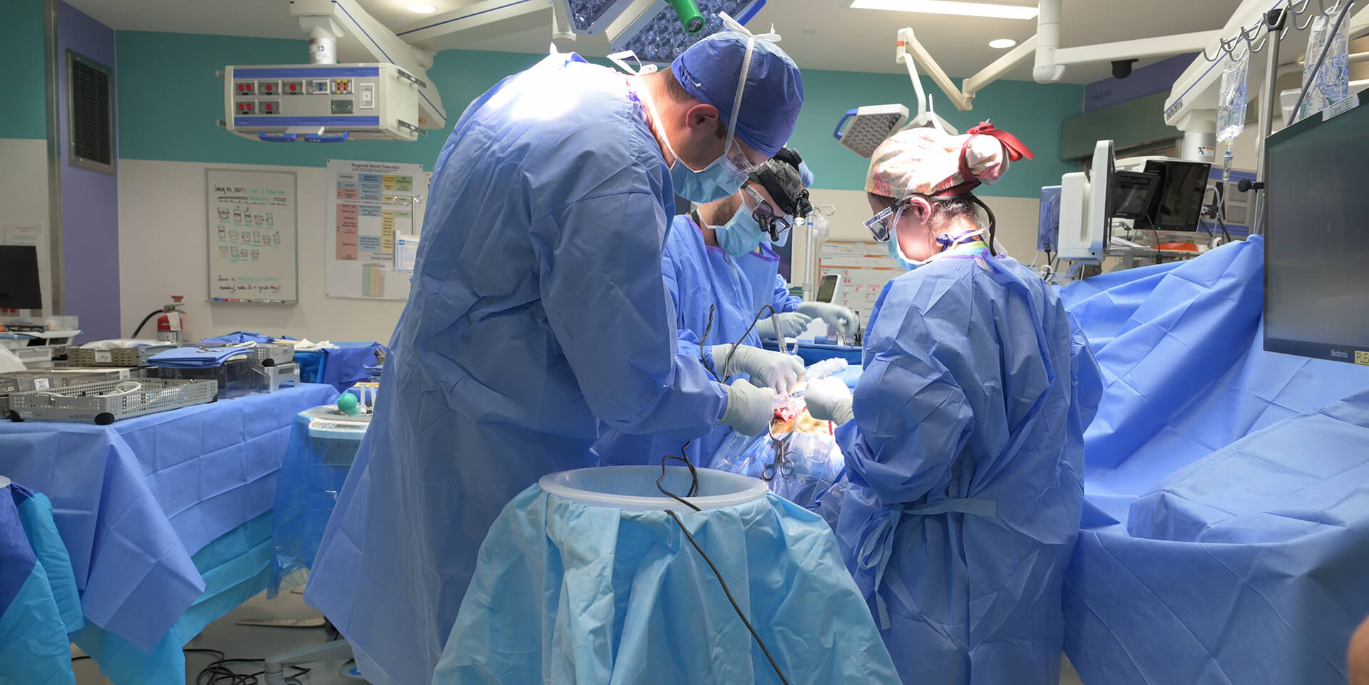 A team of pediatric neurosurgeons performing a procedure in the operating room.