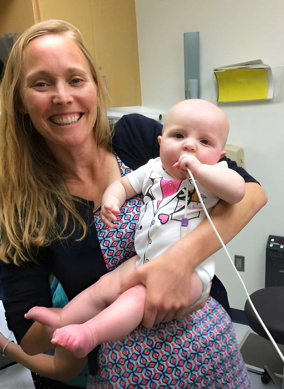 Seattle Children's Dr Reihle holds a baby