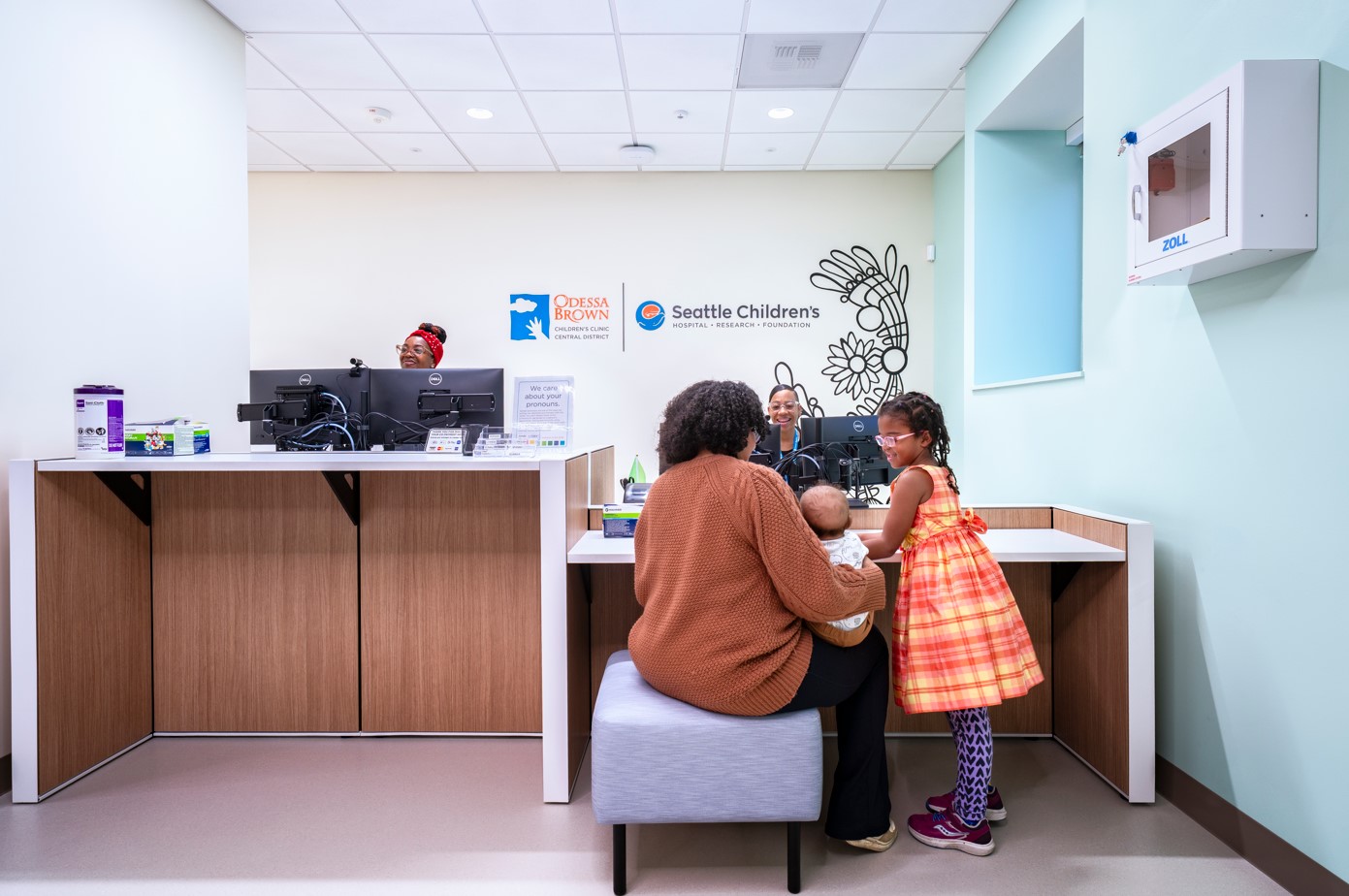 A family at the OBCC Central District reception desk