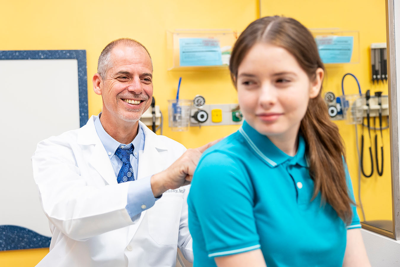 A doctor checking a patient's spine