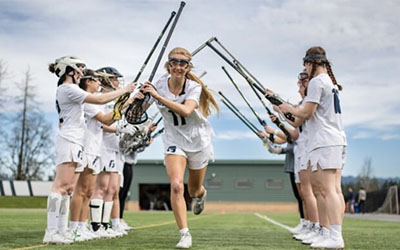 A team of female lacrosse players on the field
