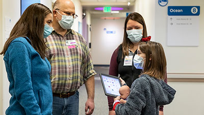 A Seattle Children's provider talking to a patient and family
