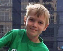 Seattle Children's patient in green shirt smiling