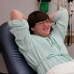 A boy relaxes in a hospital chair
