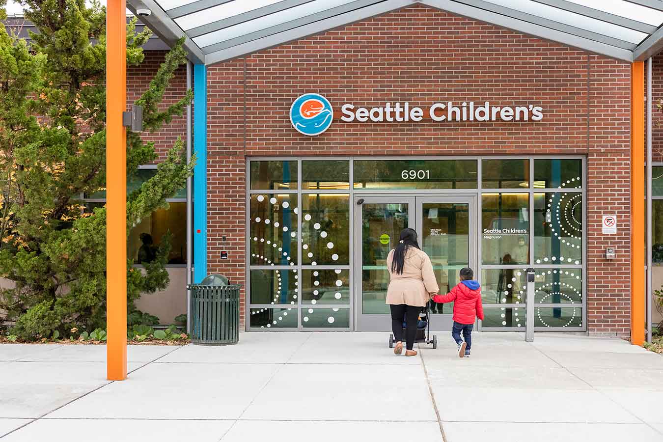 Mother and son walking to the entrance of Seattle Children's Mangnuson