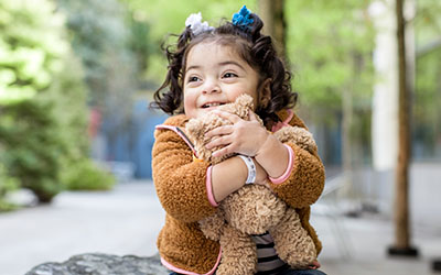A girl hugs a stuffie