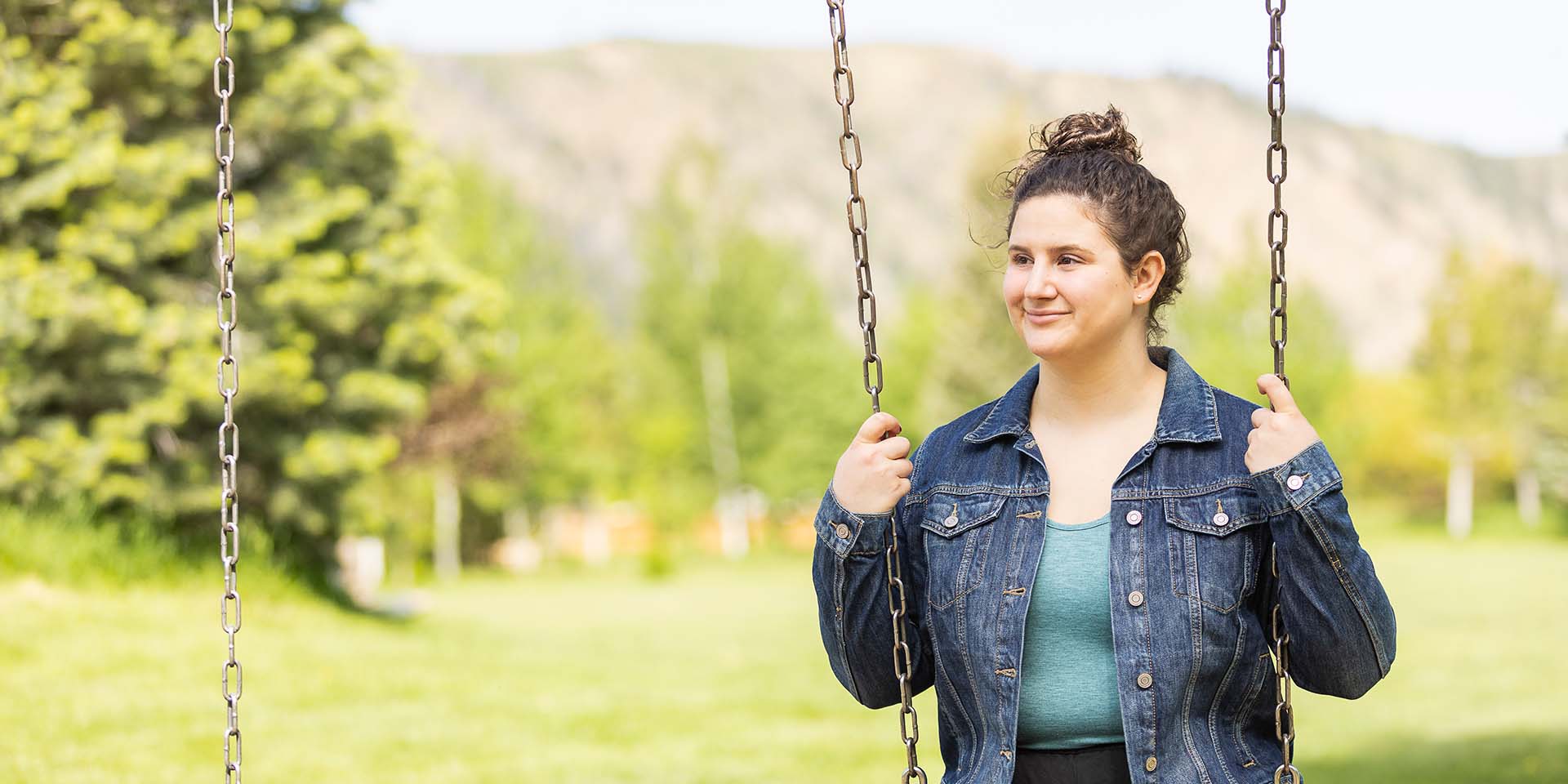 A young woman sits on a swing