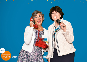 Patti Byers, Guild Association board chair (left) and Ann Shanahan, membership committee chair, shared a laugh in the photo booth.