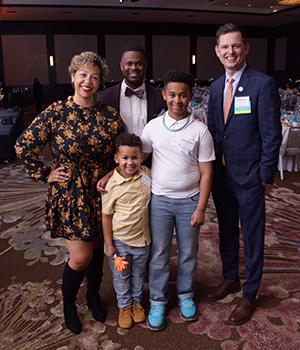 Isaac Williams, 6, was diagnosed with stage 4 high-risk neuroblastoma at 17 months old. Here, Isaac and his family — Kelli, Dennis, Isiah — are pictured with Dr. Jeff Sperring, Seattle Children’s CEO. The family shared their inspiring Seattle Children’s cancer journey with a rapt audience.