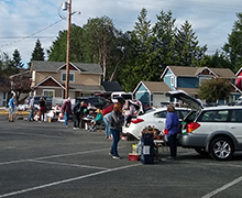 Cars parked side-by-side in an Anacortes church parking lot for a Boot Garage Sale.