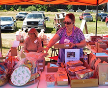 Sequim Guild members at an outdoor booth selling baked goods, jams and jellies.