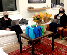 Guild member Sandy Rudy (left) texts to bidders through the Greater Giving platform while member Dianne Sabat responds to incoming helpline messages.