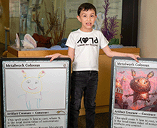 Child with extra-large Magic: The Gathering cards