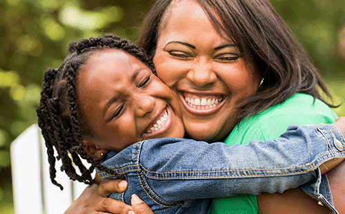 Mother and daughter hugging