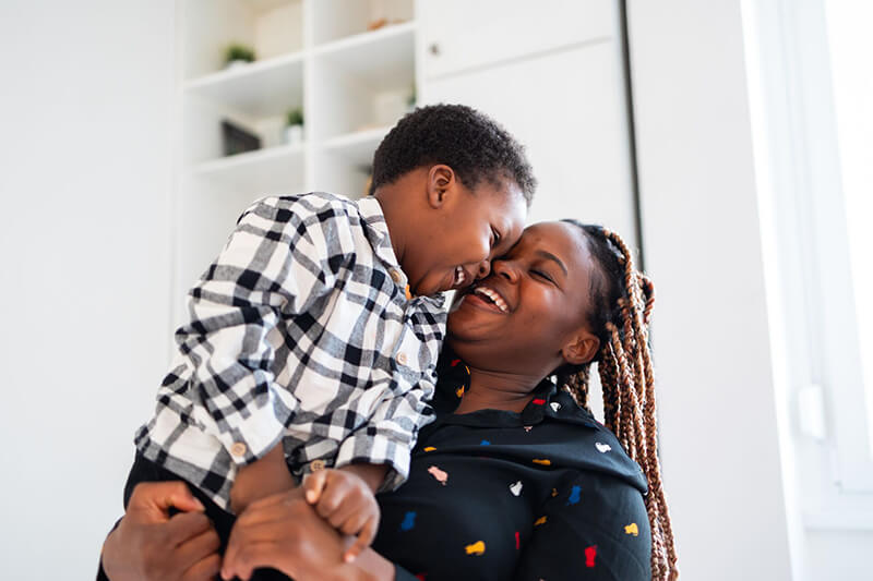Smiling mother holding her smiling son