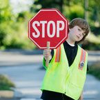 kid holding a stop sign