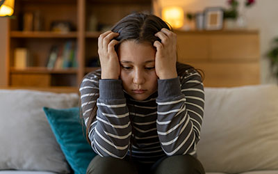 A girl holds her head