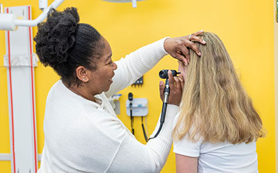 A doctor examines a teen