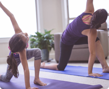 mom and daughter doing yoga