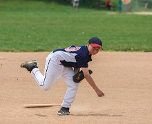 A boy pitches from the baseball mound