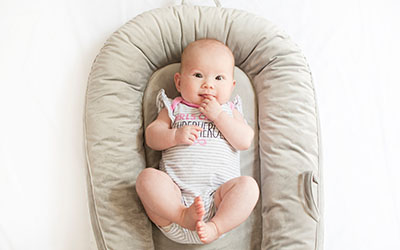 A baby in a baby lounger