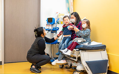 Mom and two kids in an exam room