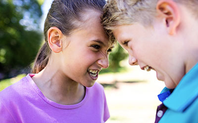 A brother and sister fighting.