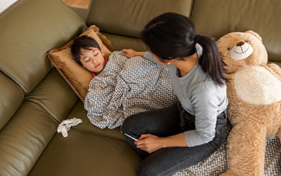 A mother tends to her sick child