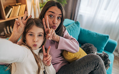 A mother and daughter make peace signs