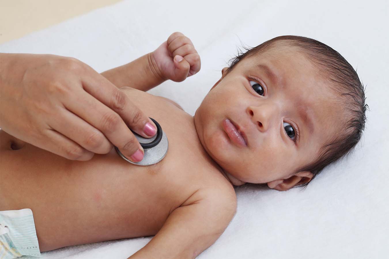 A baby is examined by a doctor.