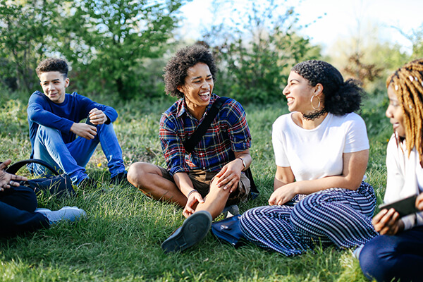 Adolescents sitting in a field