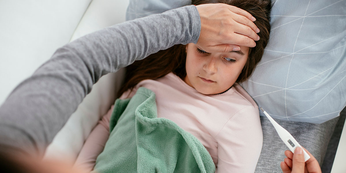 A mother checks her daughters temperature