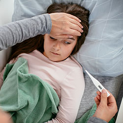 A mother checks her daughters temperature