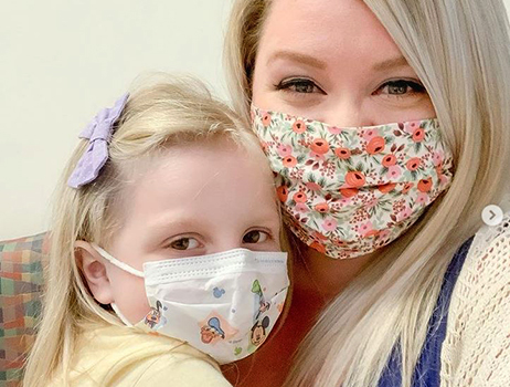 A mothers and daughter wearing masks 