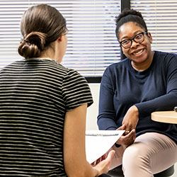 A Seattle Children's providers speaks with a teen girl.