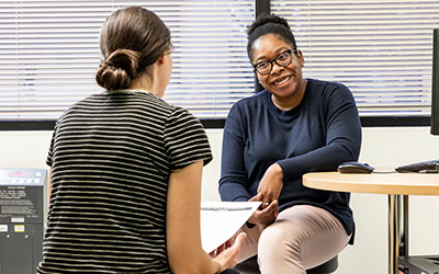 A Seattle Children's providers speaks with a teen girl.