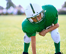 Kiddo in football pads and helmet