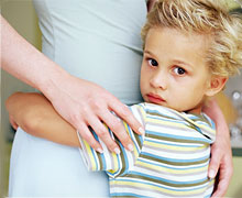 Kiddo hugging mom's legs