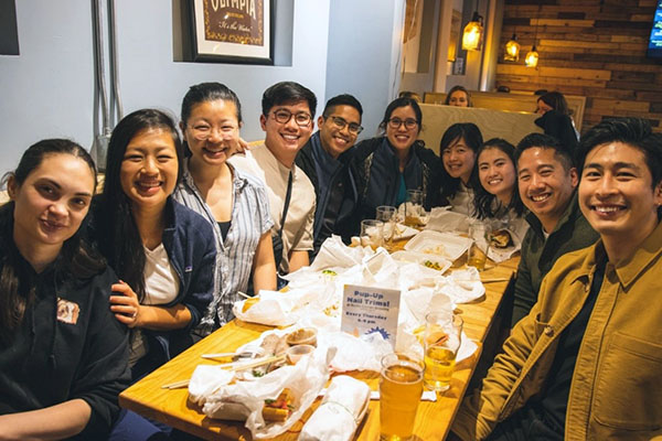 Seattle Children's residents smile for the camera at a restaurant table.