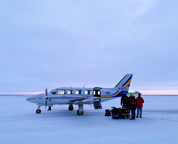 Residents board a plane
